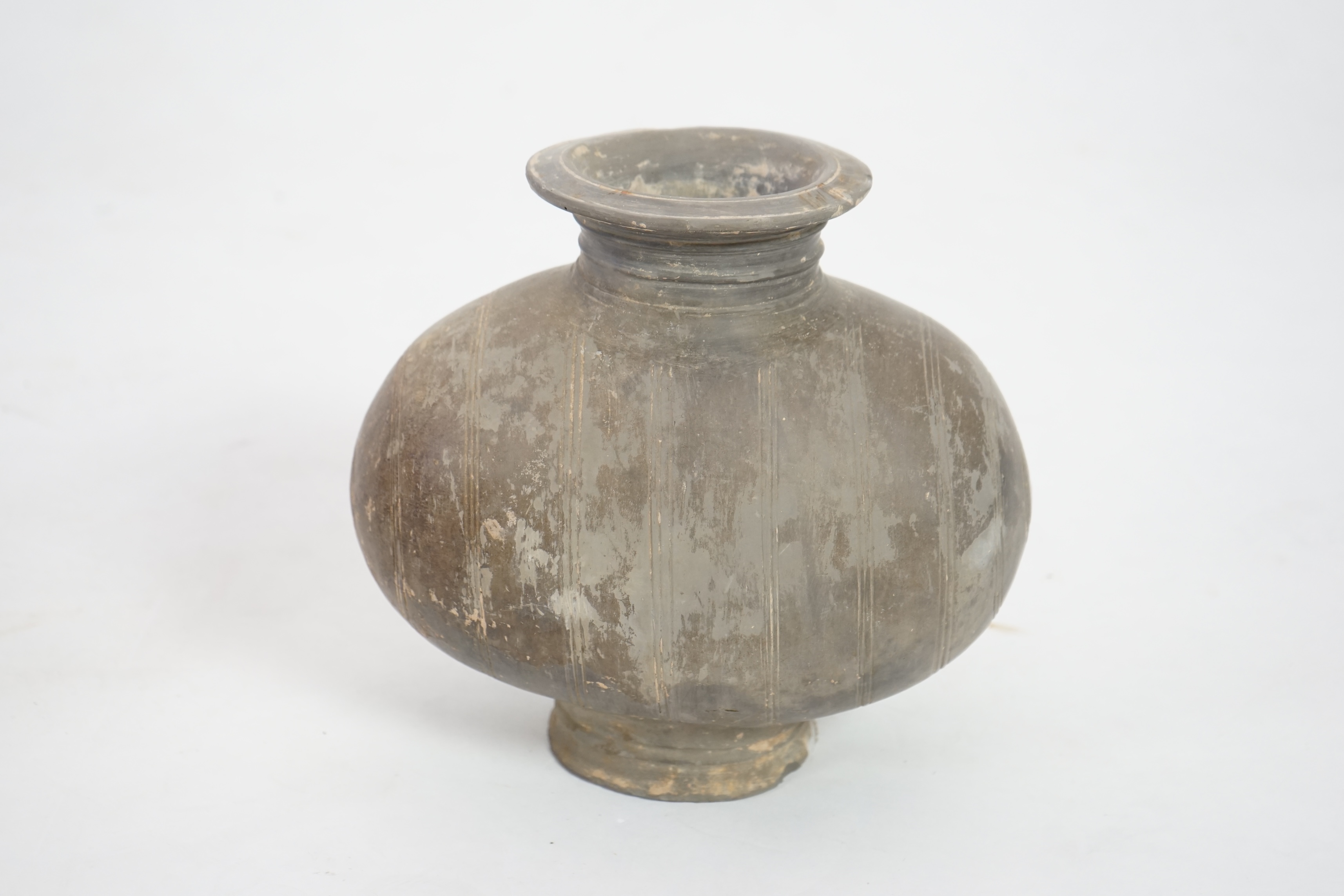 A Chinese incised and burnished pottery cocoon jar, Western Han Dynasty (206 BC-AD 8)